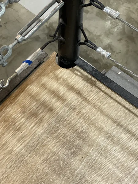 A closer look at how the flooring follows the wall and railing at the landing.