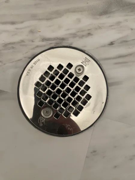 An overhead view of the fitted planks around the drain cover.