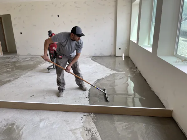Hands-on work across the room helps prepare the base for the new flooring.