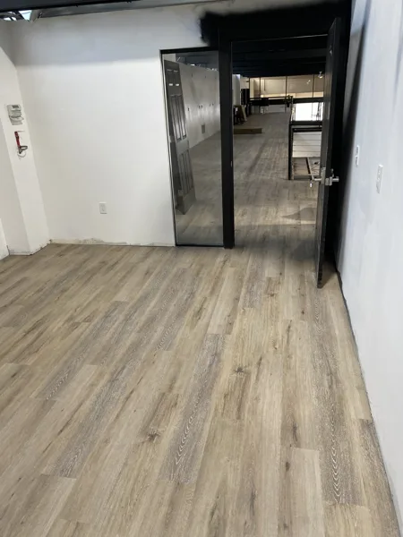 A view of the LVP installation work, finished areas or flooring details at The Beauty Stop.
