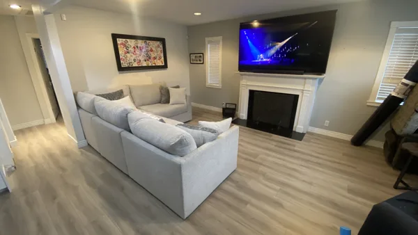 Wood-look plank flooring through the bungalow’s living area and adjoining kitchen.