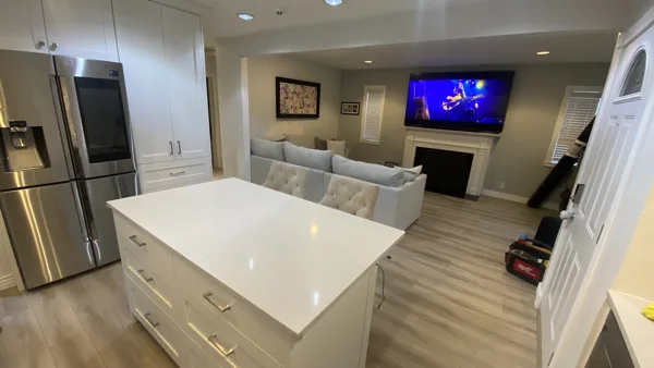 Wood-look plank flooring through the bungalow’s living area and adjoining kitchen.